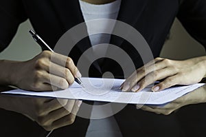 A woman signing a contract